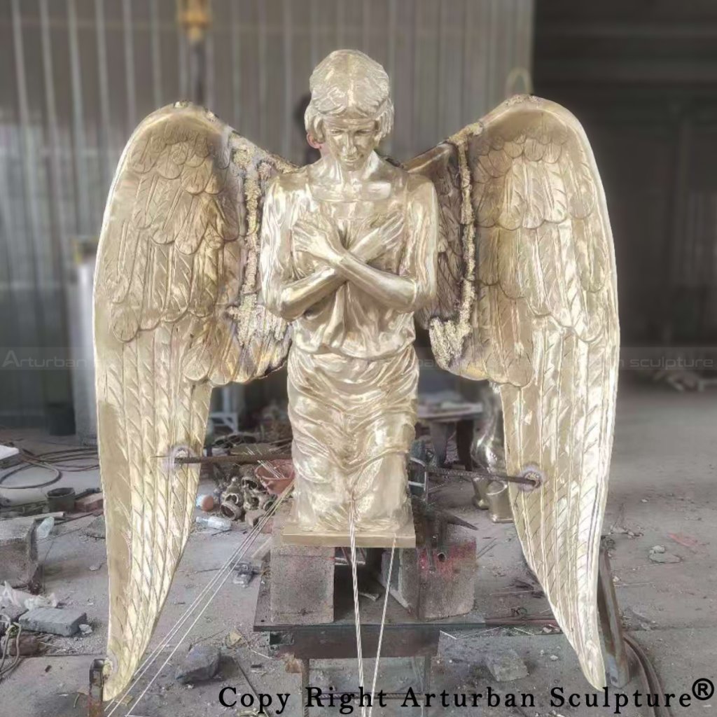 Front view of a partially assembled bronze kneeling angel statue