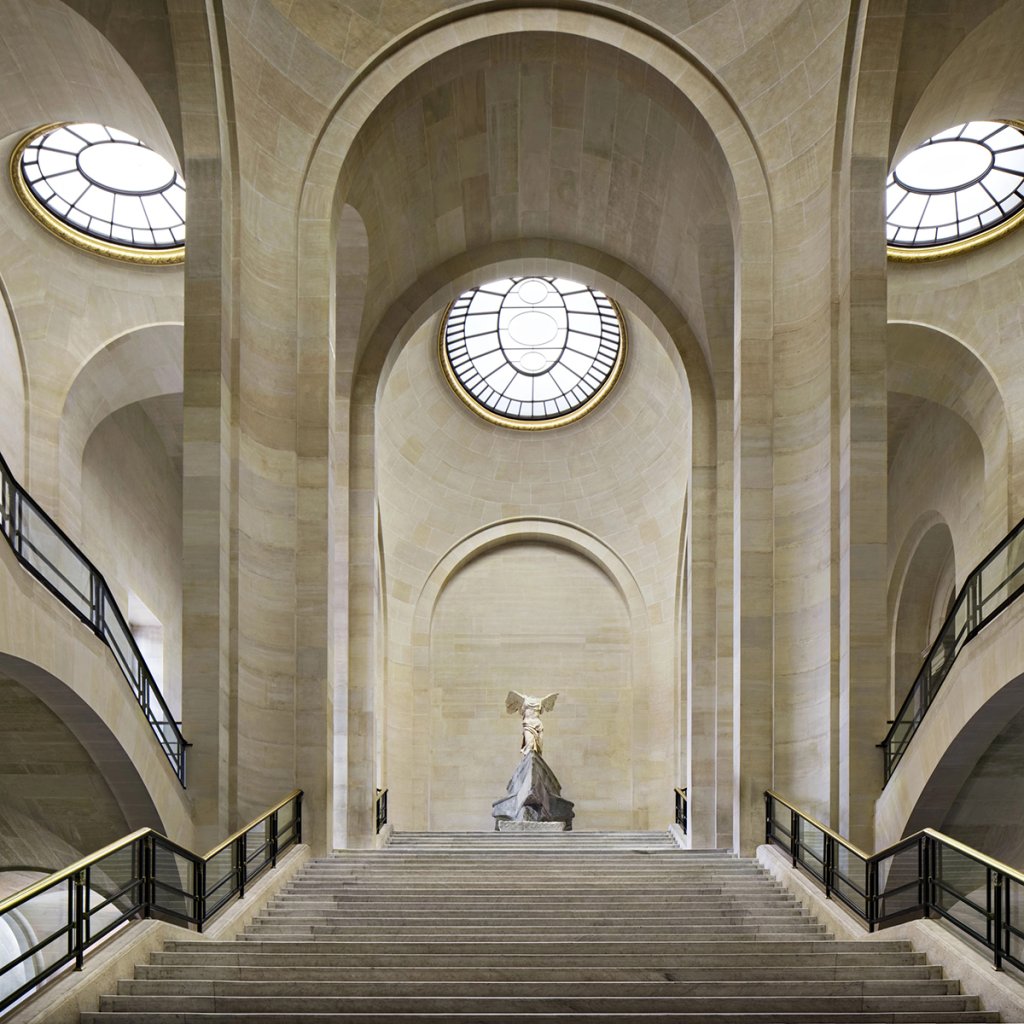 The Winged Victory of Samothrace displayed at the top of the grand Daru staircase in the Louvre Museum