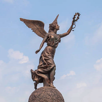 A bronze statue of nike holding a laurel wreath