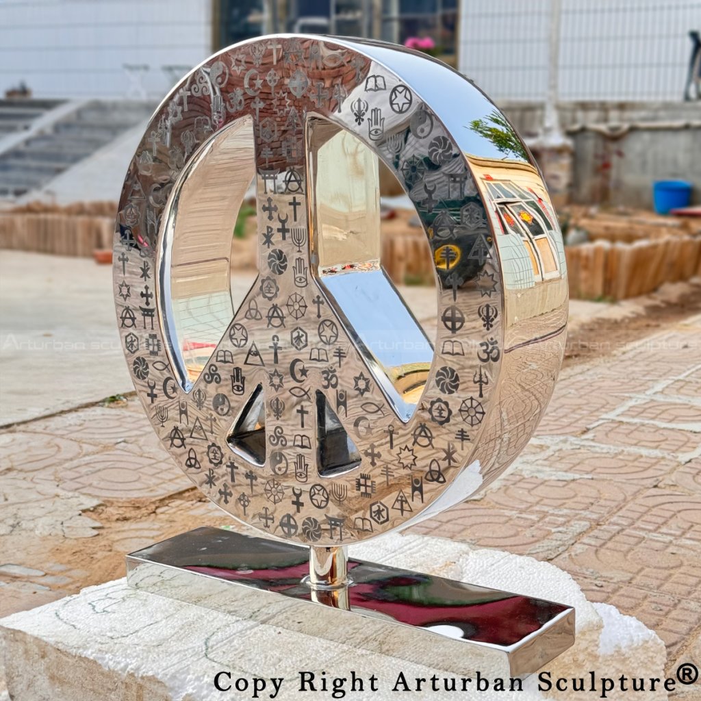 Mirror-polished stainless steel symbol of peace statue engraved with various world religion icons
