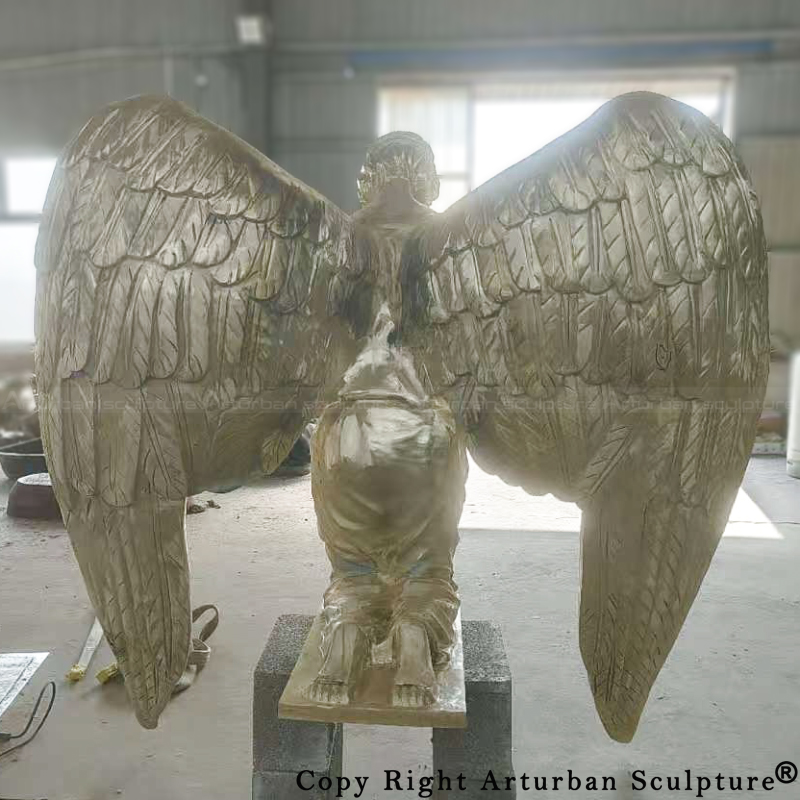 Rear view of Bronze kneeling angel statue during welding process