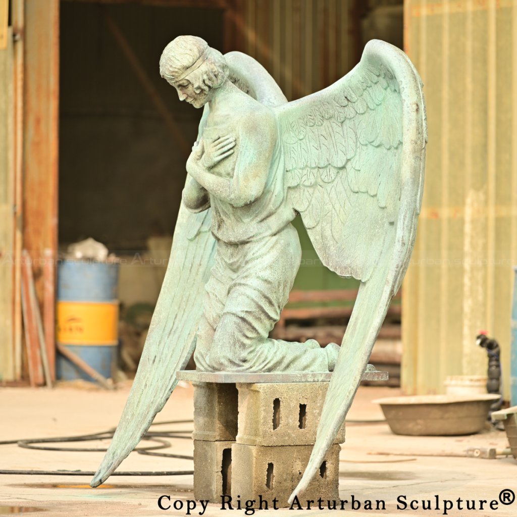 bronze angel statue kneeling with crossed arms