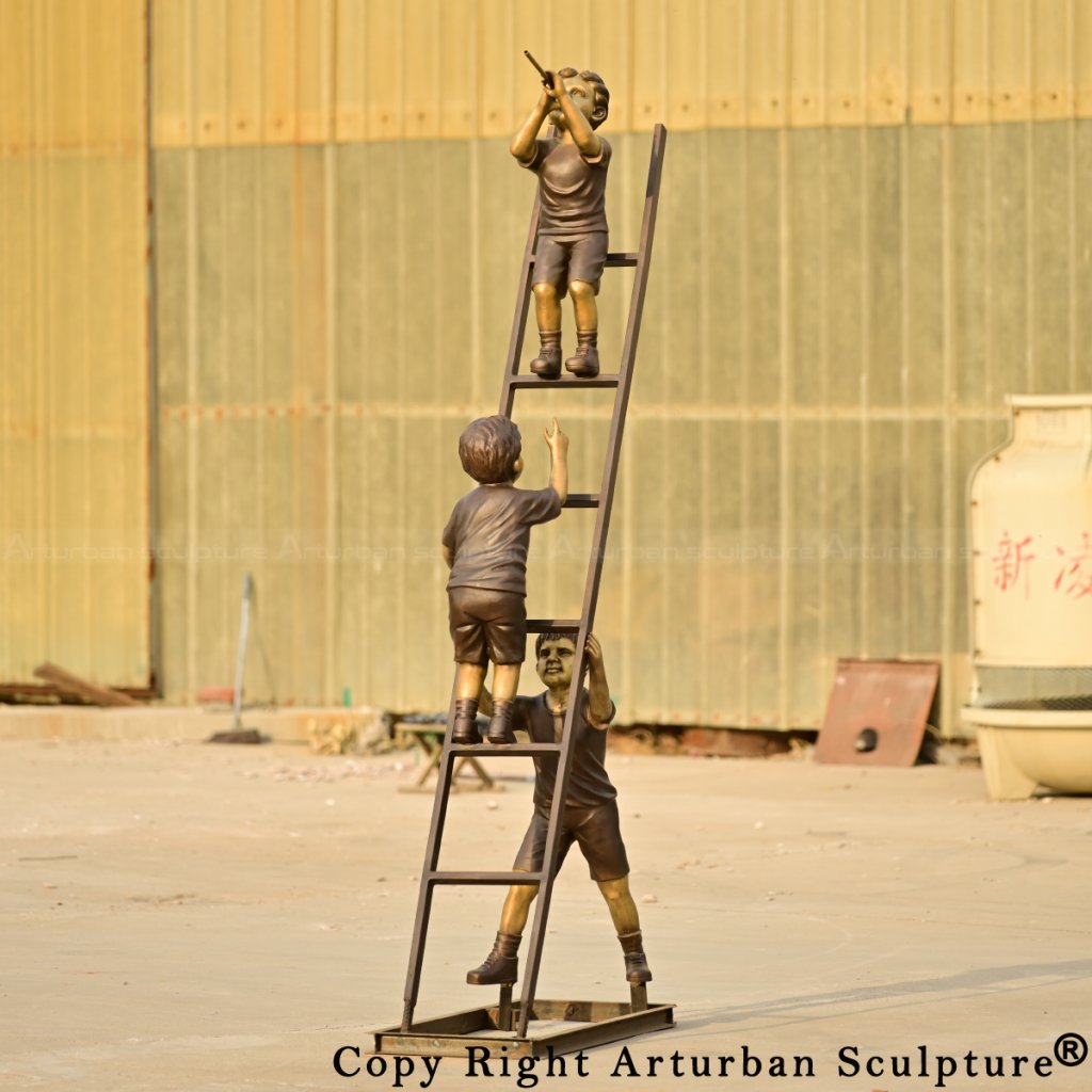 three bronze children on a ladder statue, with the top child playing a flute