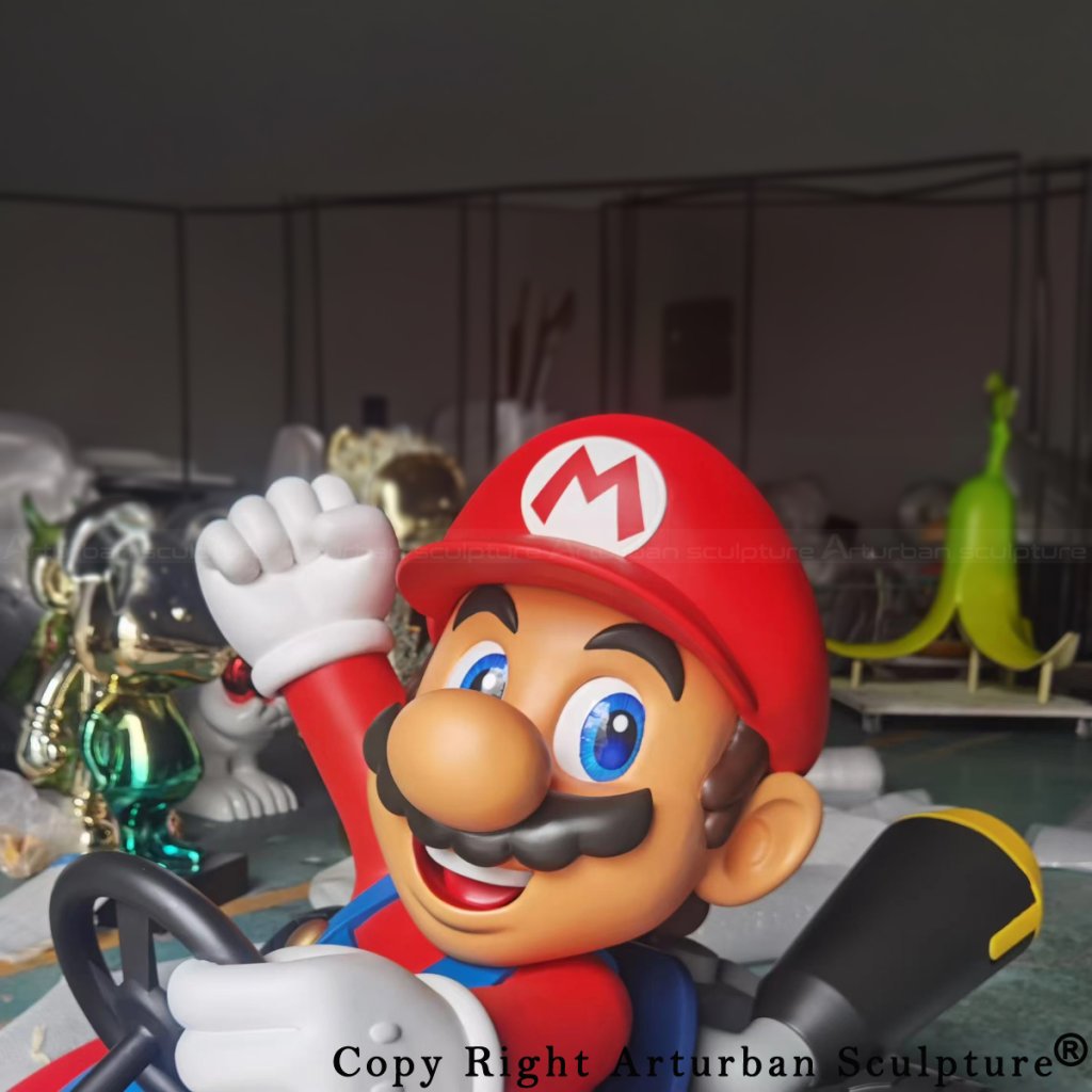Close-up of a Mario Kart fiberglass statue featuring Mario raising his fist and smiling