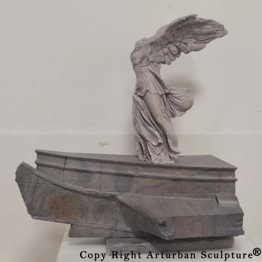 bronze Winged Victory of Samothrace replica on ship base