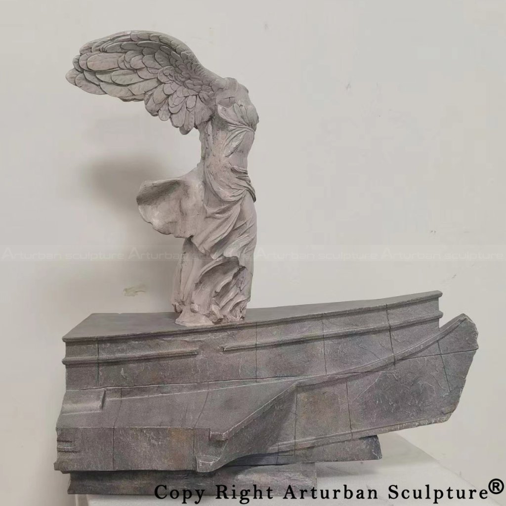 bronze Winged Victory of Samothrace replica on ship base showing detailed wing feathers and flowing drapery