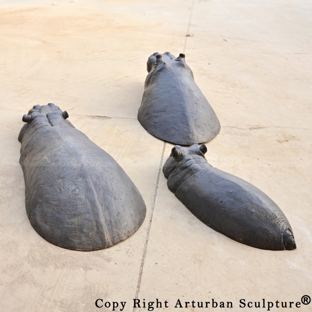 Back view of three Bronze Hippopotamus sculptures