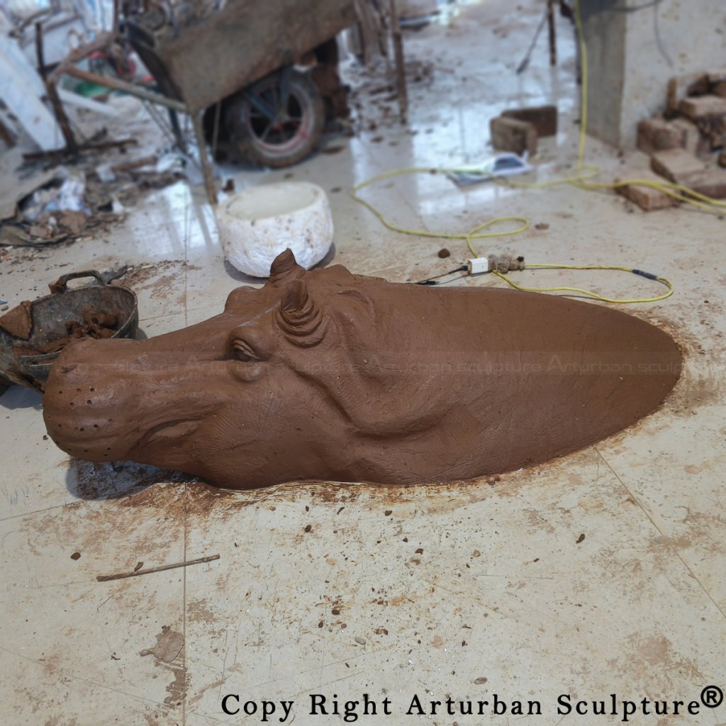 Clay model of a Bronze Hippopotamus sculpture in progress, showing fine facial details