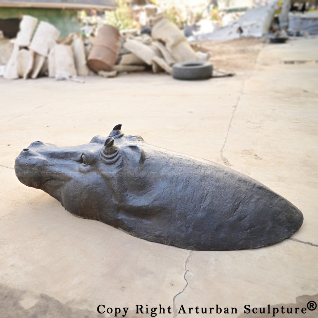 Close-up of a Bronze Hippopotamus sculpture featuring detailed ears, eyes, and snout