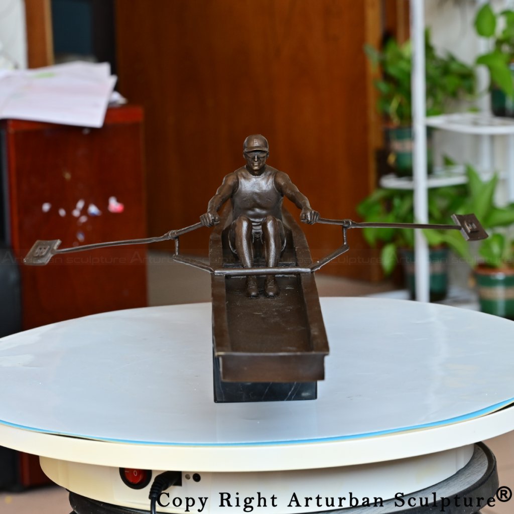 Front view of rowing sculpture with symmetrical oars and strong posture