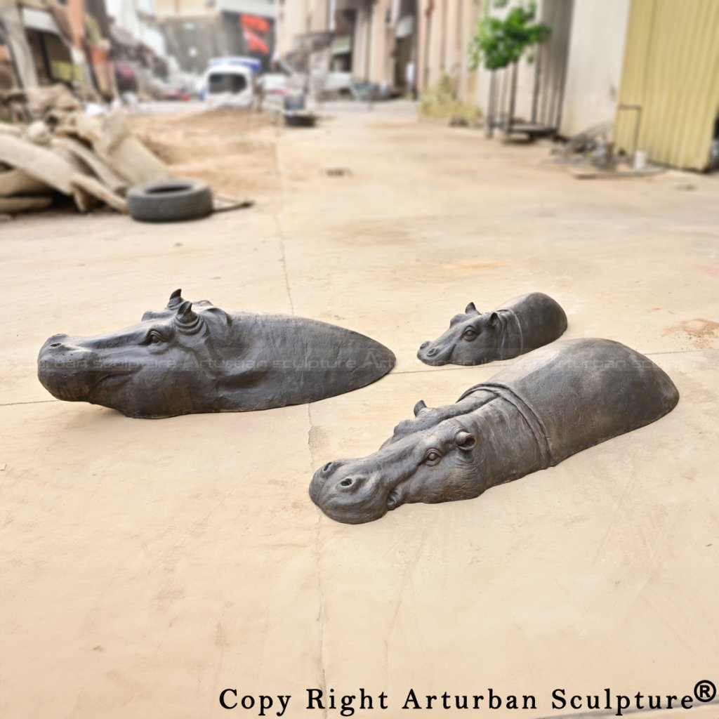 Outdoor display of Bronze Hippopotamus sculptures, partially submerged design mimicking natural water behavior