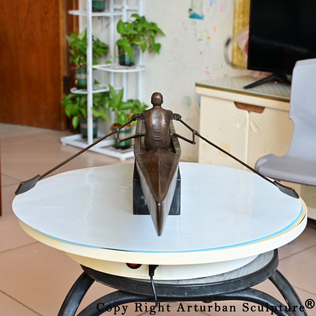 Rear view of rowing sculpture displaying back muscles and tapered boat tail