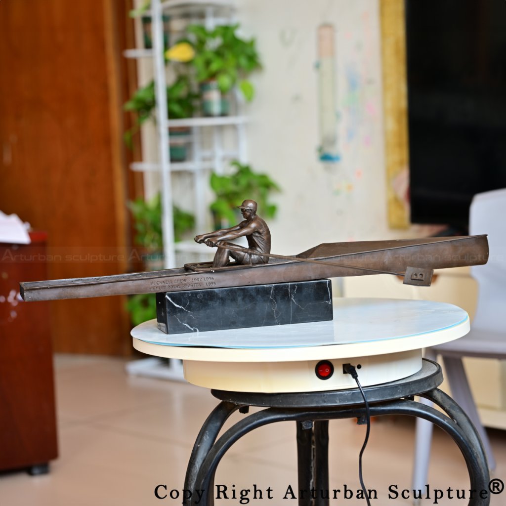bronze rowing sculpture showing full oar extension