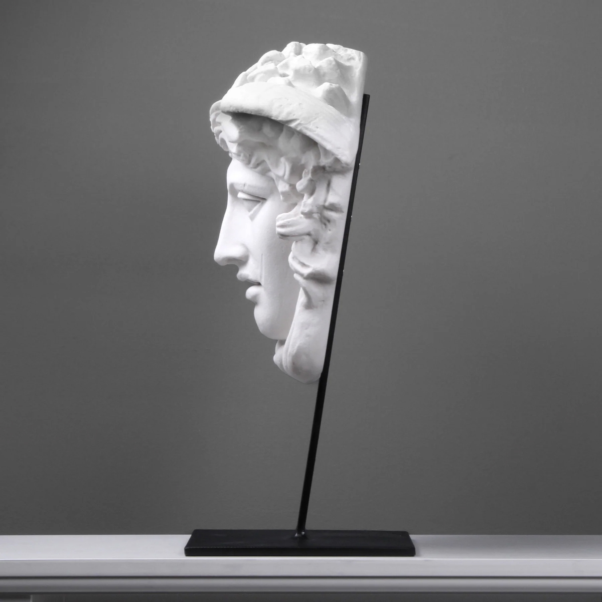Angled profile of marble Medusa Head Statue for Sale with detailed curls
