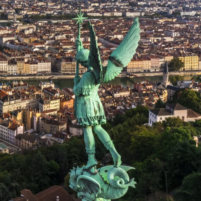 Archangel Michael statue above Lyon cityscape on top of Fourvière Basilica