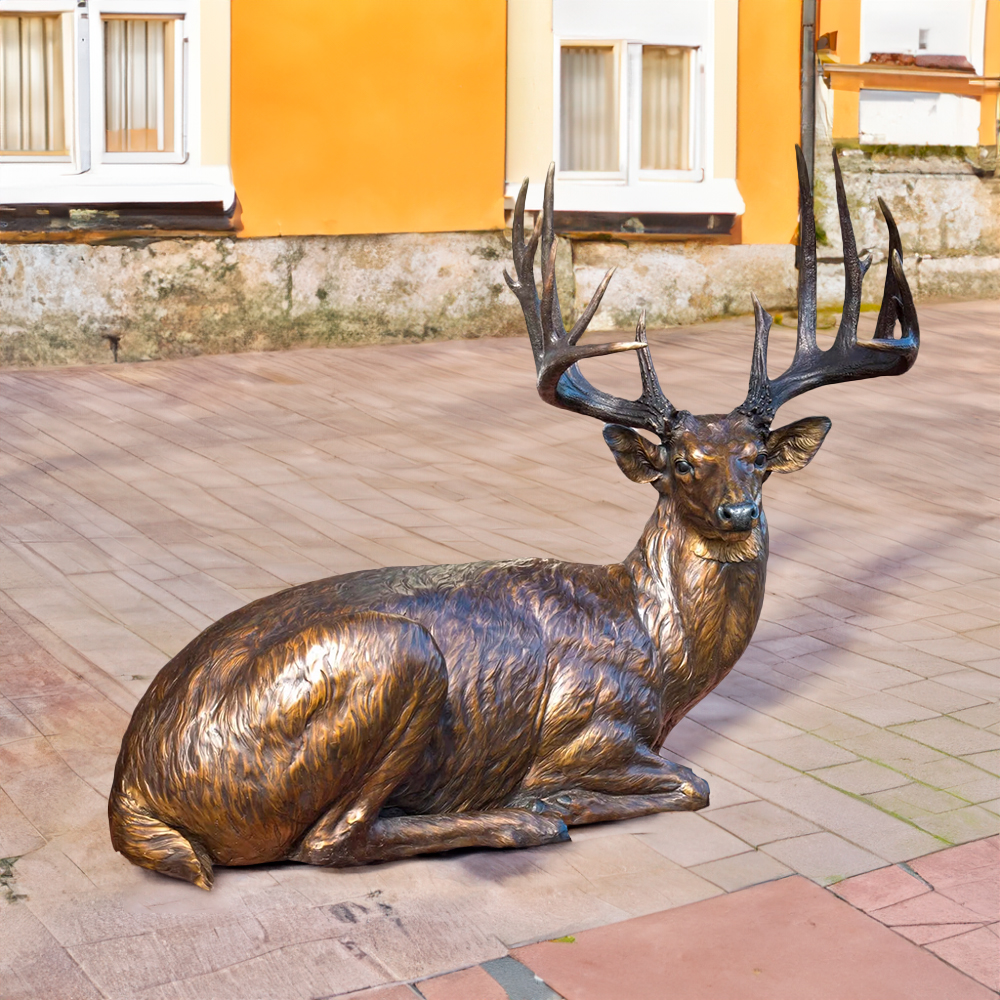 Bronze Buck Sculpture depicting a resting white-tailed deer