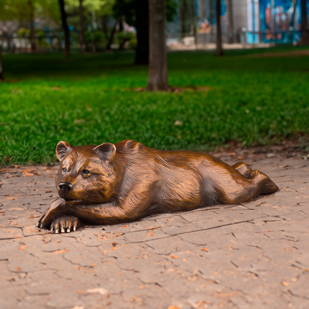 Bronze Large Bear Garden Ornament featuring a lifelike grizzly bear lying down with its front paws crossed