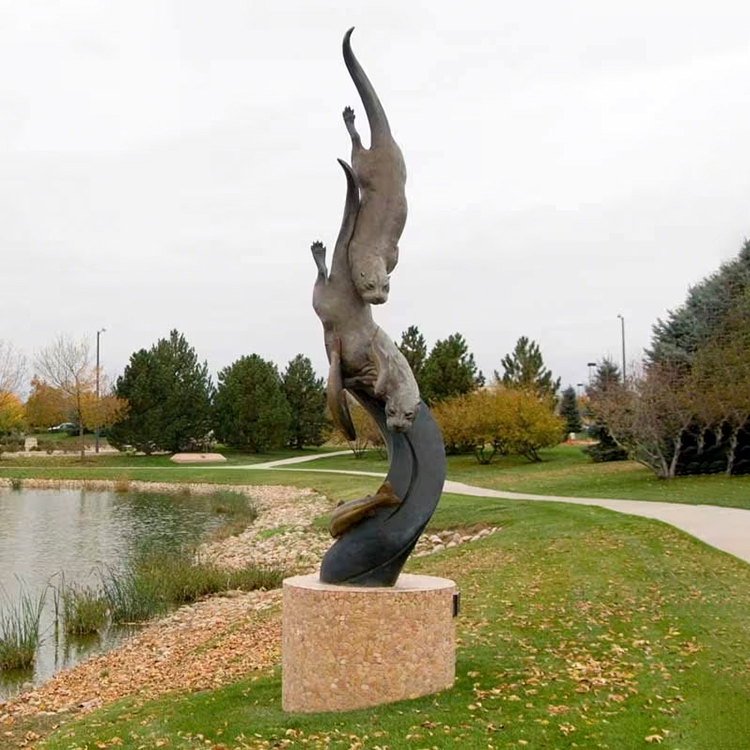Bronze Otter Garden Sculpture showing two river otters diving to chase salmons