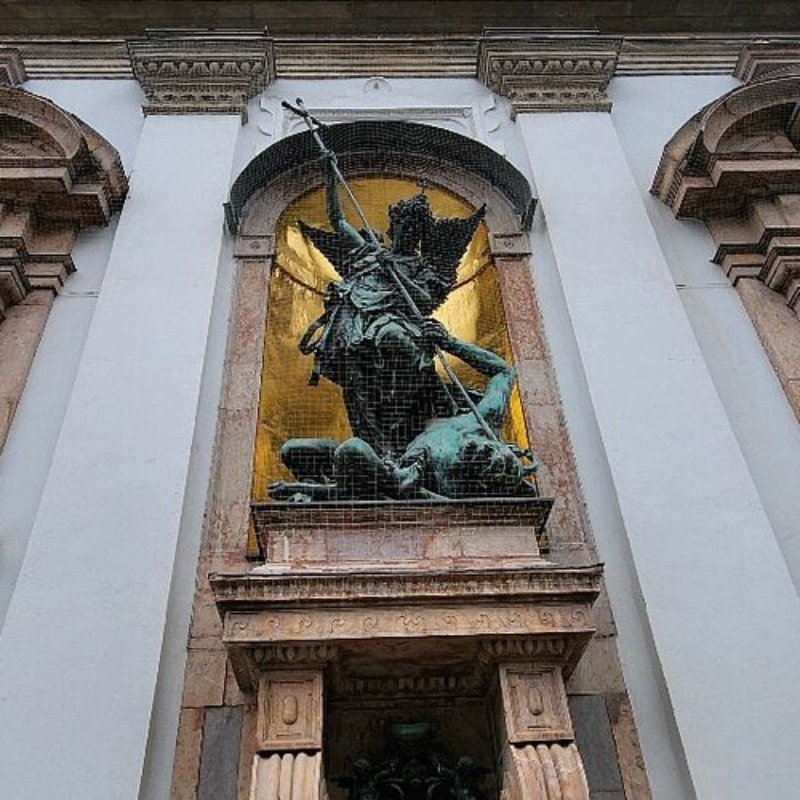 Bronze statue of Saint Michael slaying Satan in a niche at St. Michael’s Church, Munich