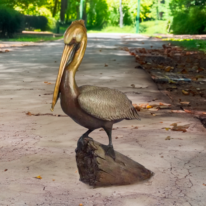 Brown Pelican Statue in bronze, featuring a lifelike pelican resting on a rock with golden beak and textured feathers