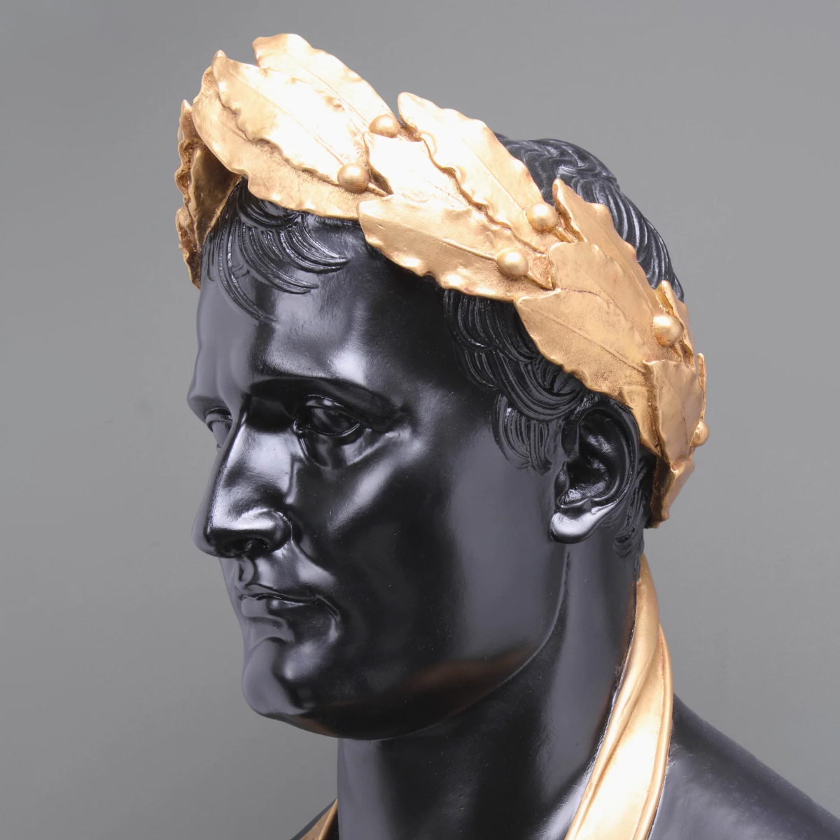 Close-up detail of Napoleon Bonaparte marble bust with golden laurel crown