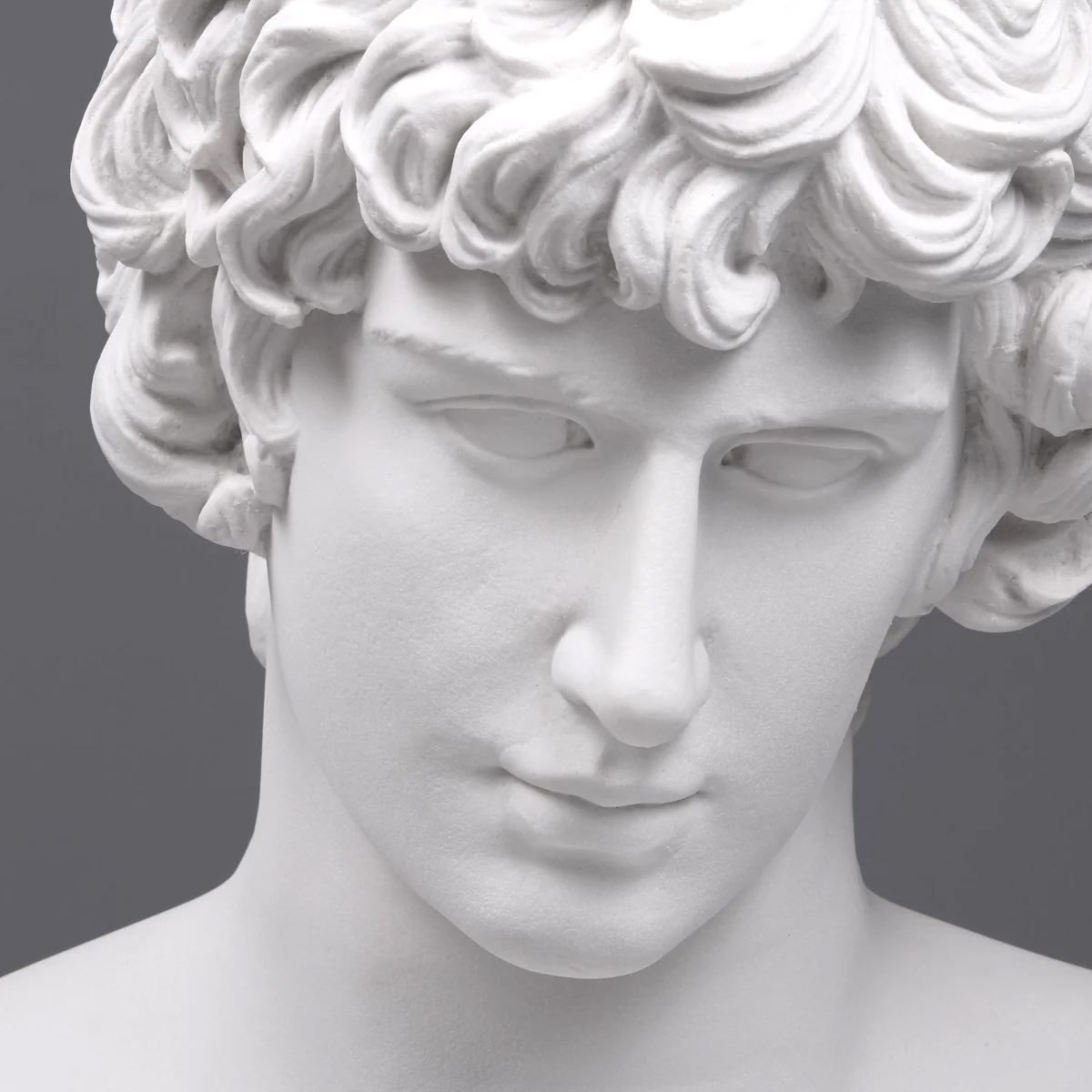 Close-up of Antinous statue for sale showing serene face and curly marble hair