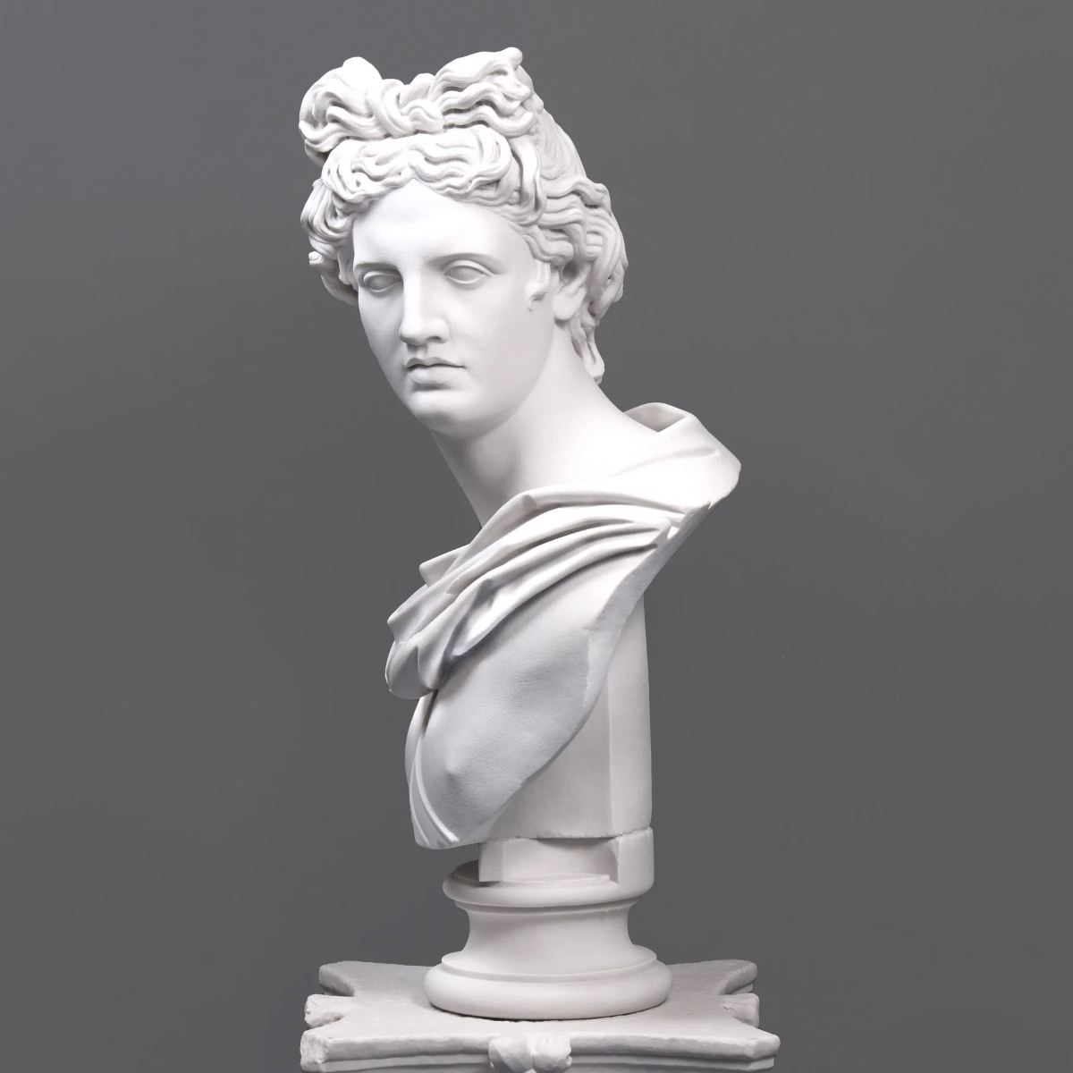 Frontal angle of Apollo Marble Bust with classical facial expression and folded garment