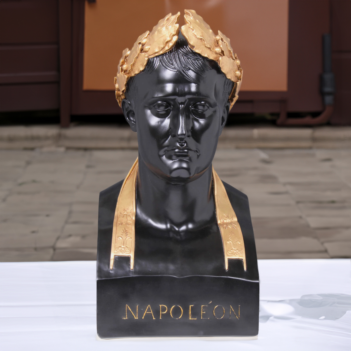 Frontal view of Napoleon Bonaparte bust sculpture with gold collar and “NAPOLEON” inscription