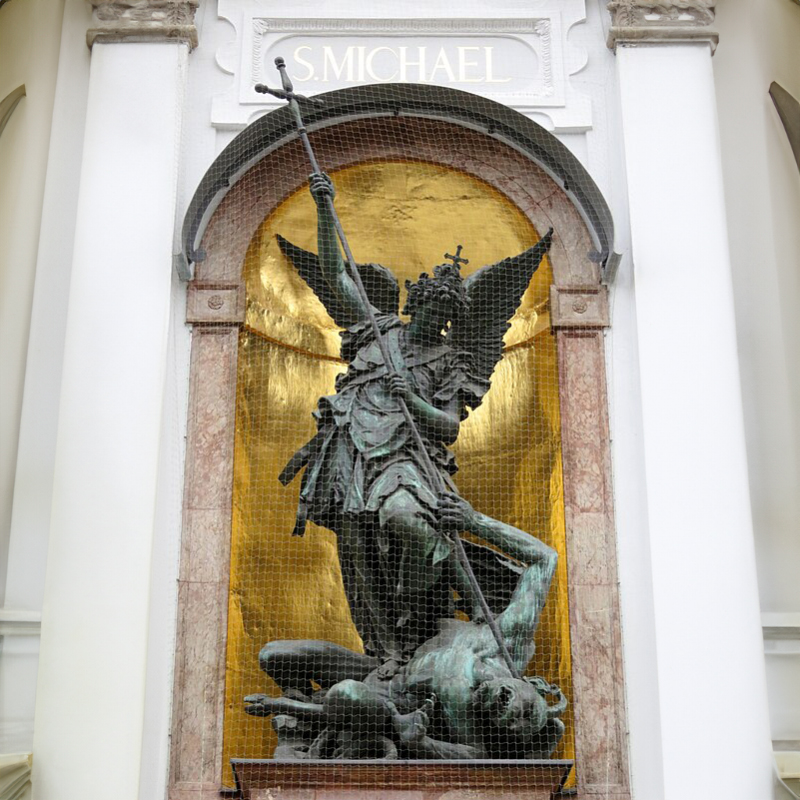 Full view of Saint Michael defeating Satan sculpture on the façade of St. Michael’s Church in Munich, Germany