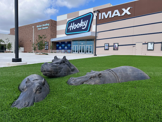 Hippo sculpture installation display on the grass