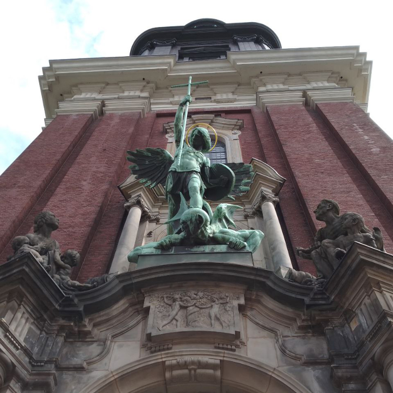 Low-angle view of Michael defeating Satan sculpture