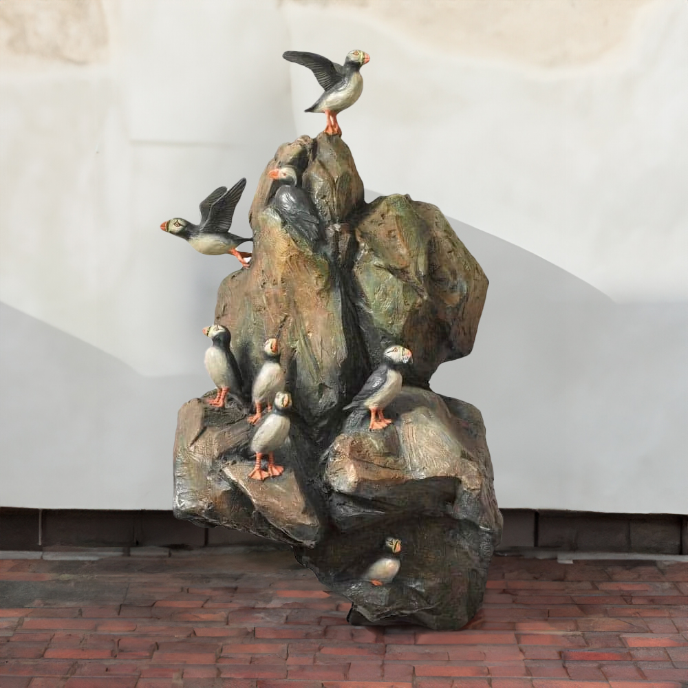 Realistic bronze Puffin Garden Statue with colorful puffins perched on natural rock formation