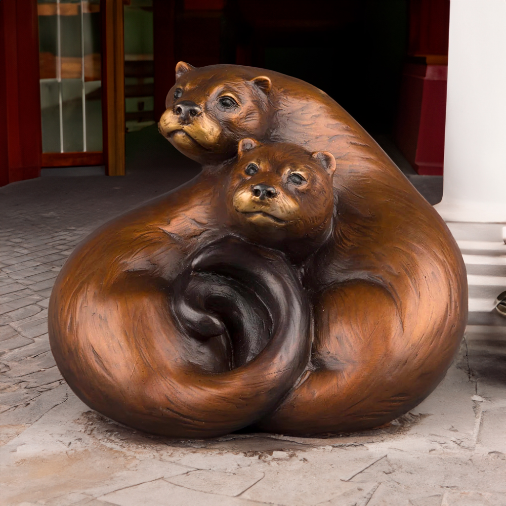 River Otter Sculpture featuring two otters curled together with intertwined tails in a smooth bronze finish