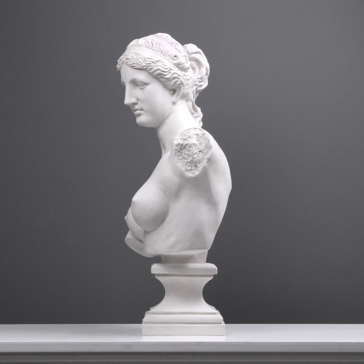 Side profile of the Aphrodite Bust Sculpture showcasing graceful feminine features in marble