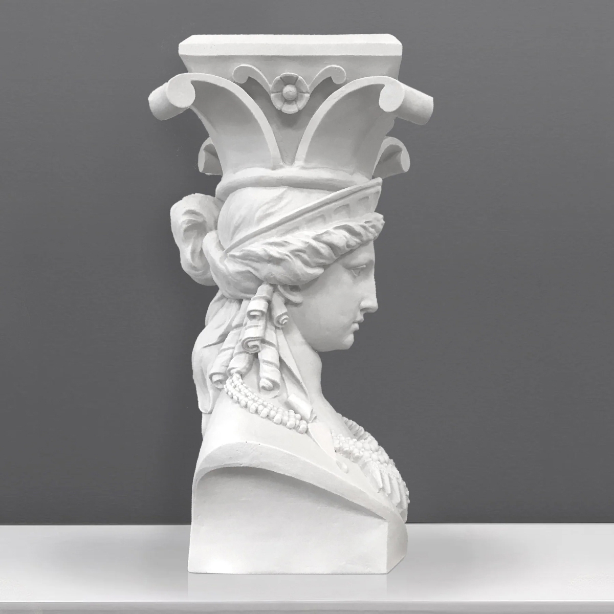 Side profile of the Caryatid bust Sculpture, highlighting the column-like crown and draped fabric details