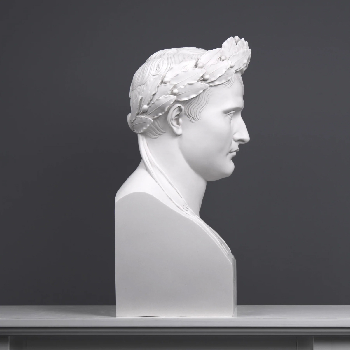 Side profile of white marble Napoleon bust with laurel crown