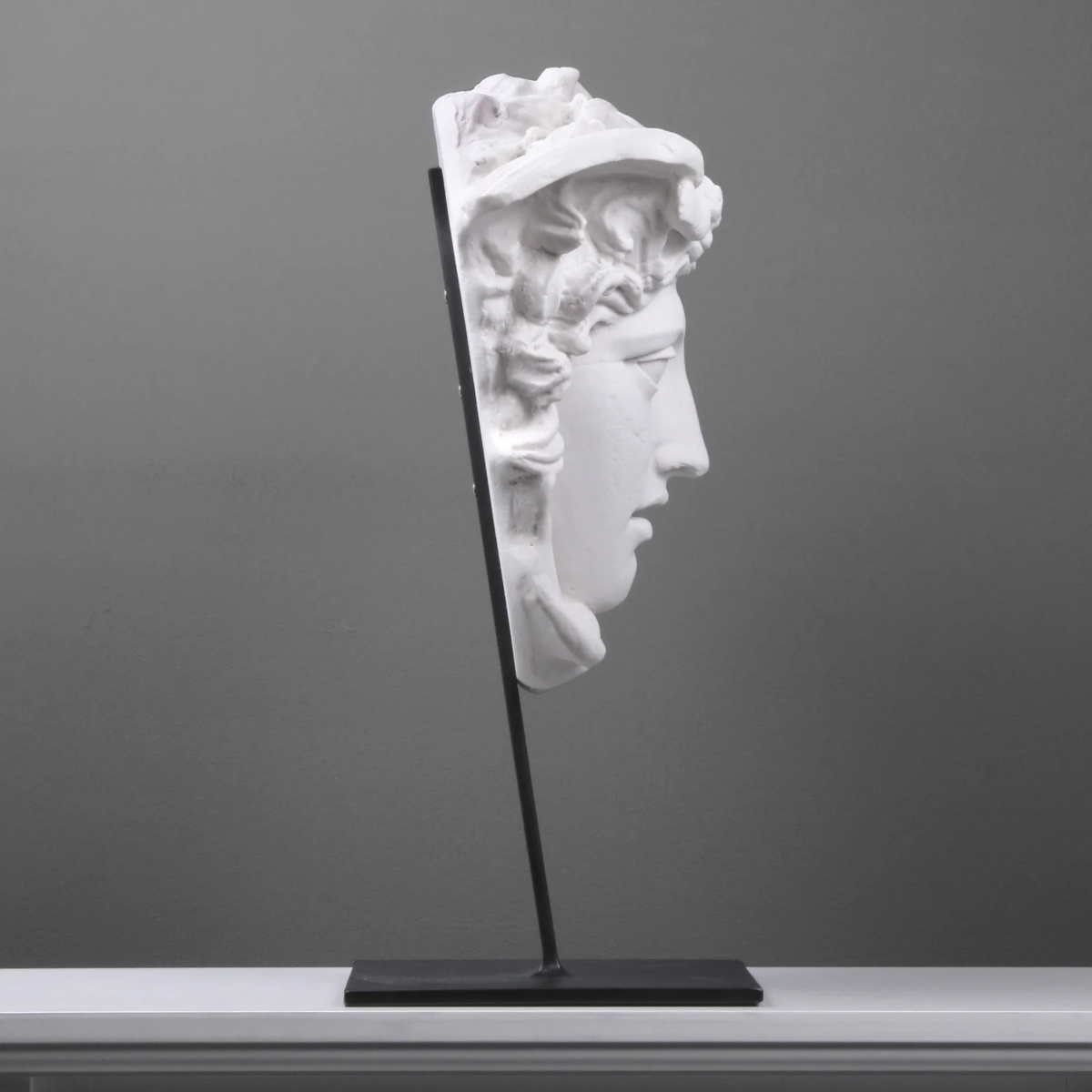 Side view of marble Medusa Head Statue for Sale on iron stand