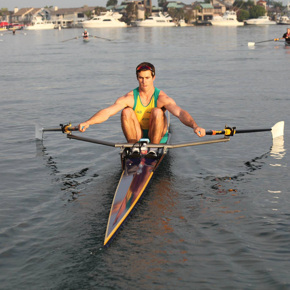 Single sculls rowing athlete on water