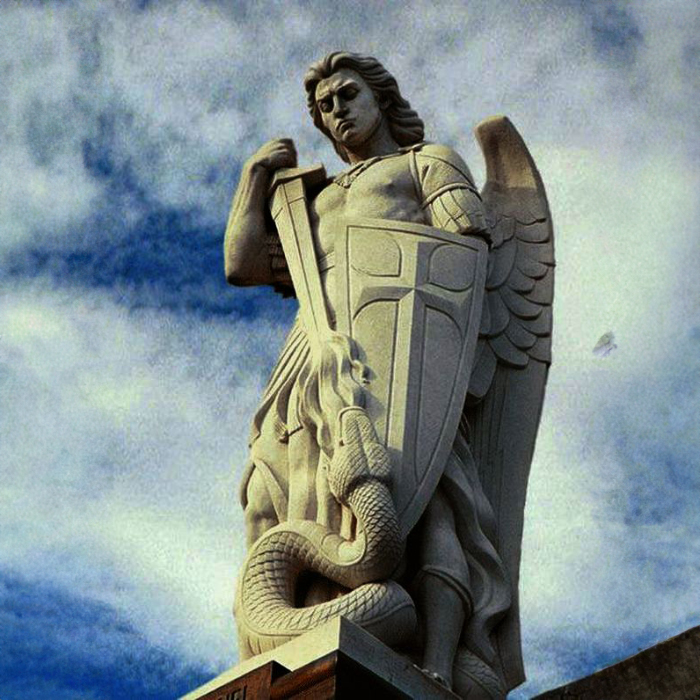 Stone statue of Archangel Michael with shield and sword, stepping on a serpent