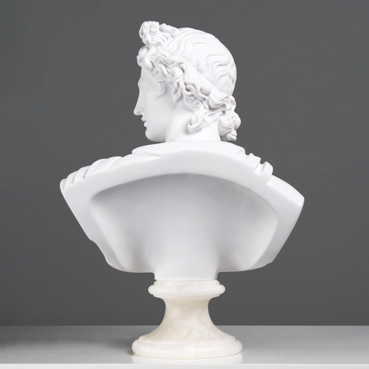 back view of the marble Apollo Head Sculpture showing the flowing curls