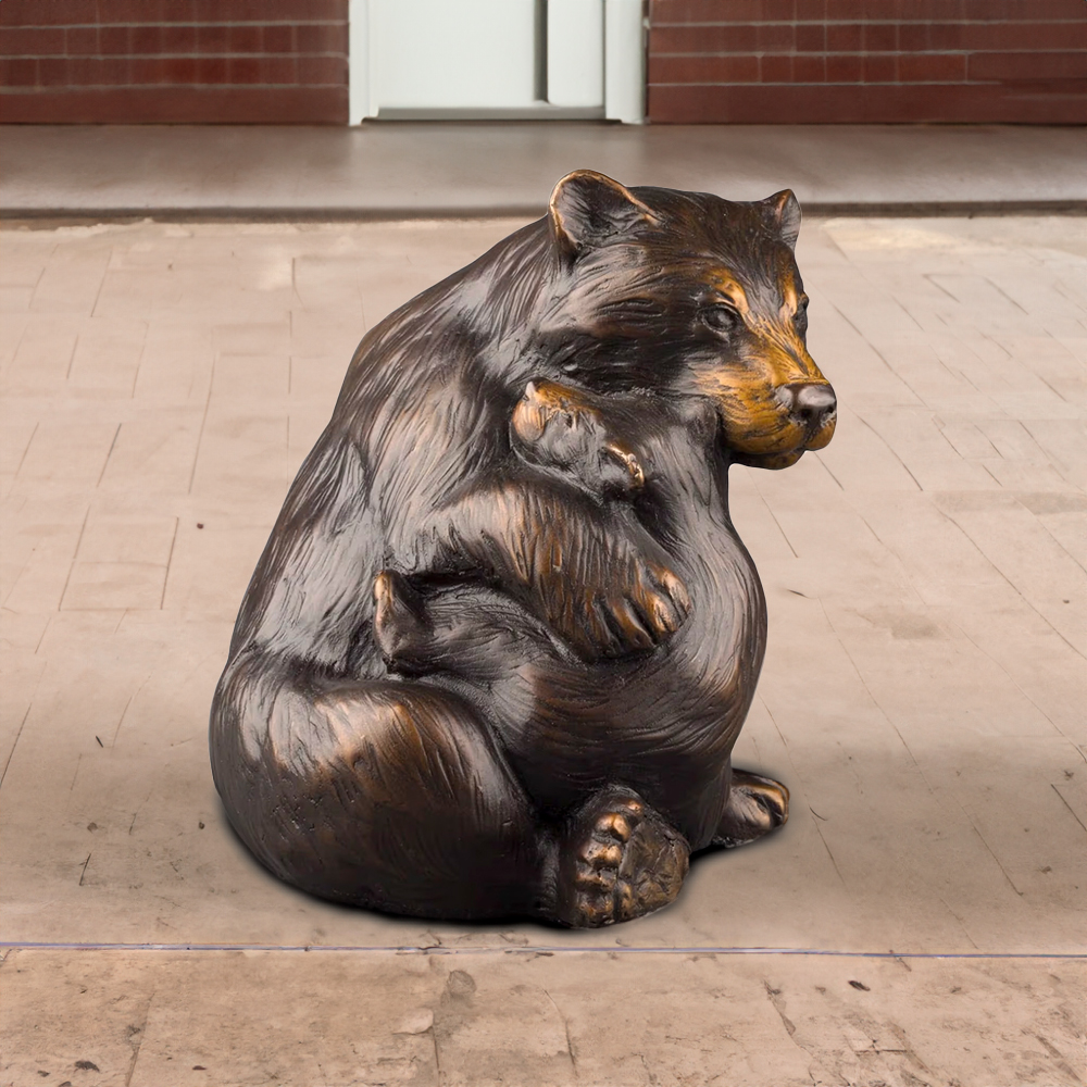 black Bear Sculpture for Sale featuring a bronze mother bear holding her cub in a seated pose