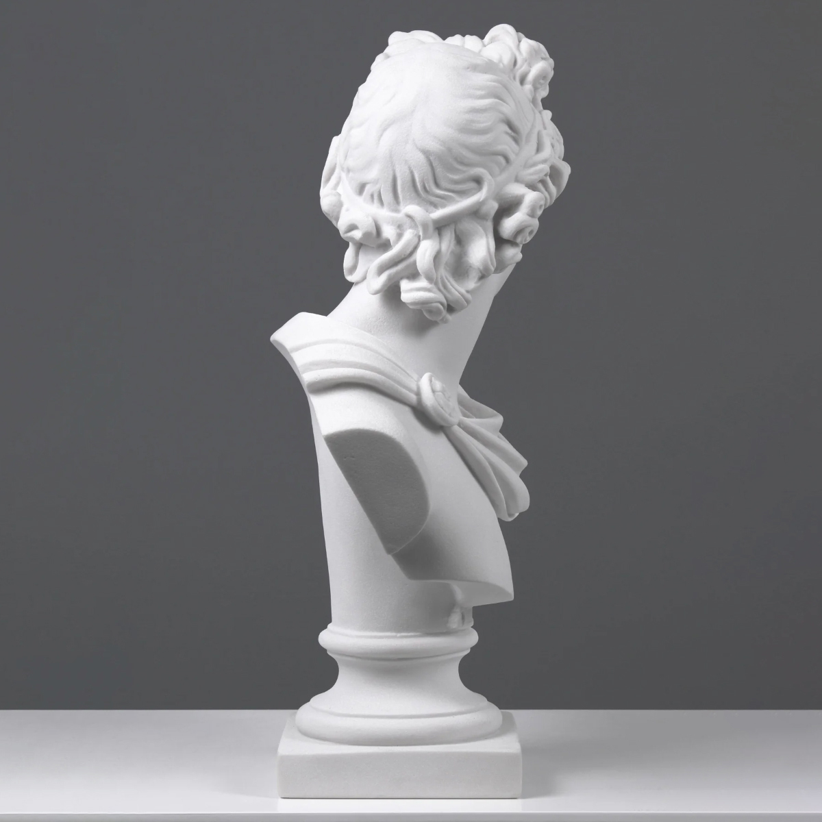 marble Apollo Belvedere Head bust, emphasizing the intricate curls and graceful neck line