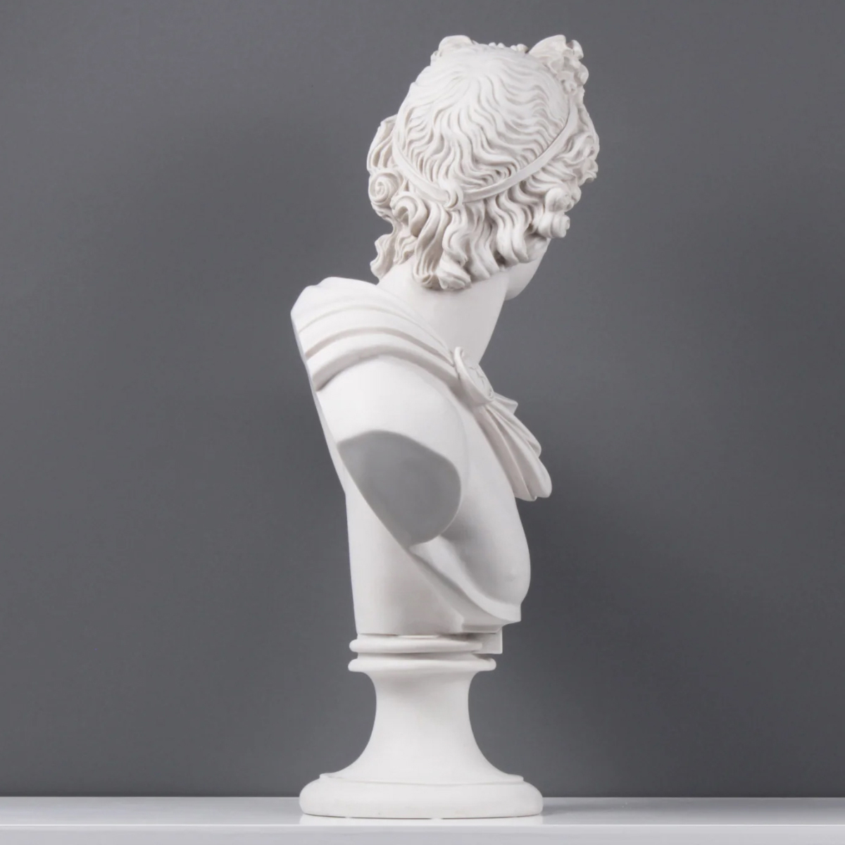 marble Apollo Head Bust with detailed facial structure and draped shoulder cloth