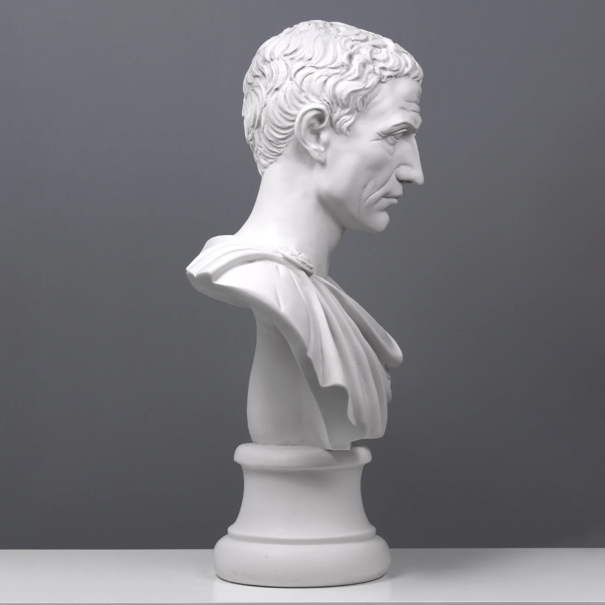 side view of Julius Caesar Marble Bust with detailed carving on Roman garment
