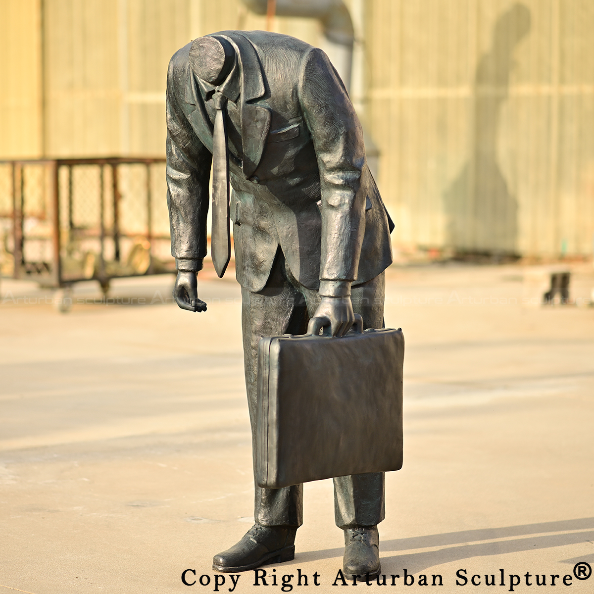 bronze Corporate Head Sculpture's front, highlighting the empty collar and dangling necktie