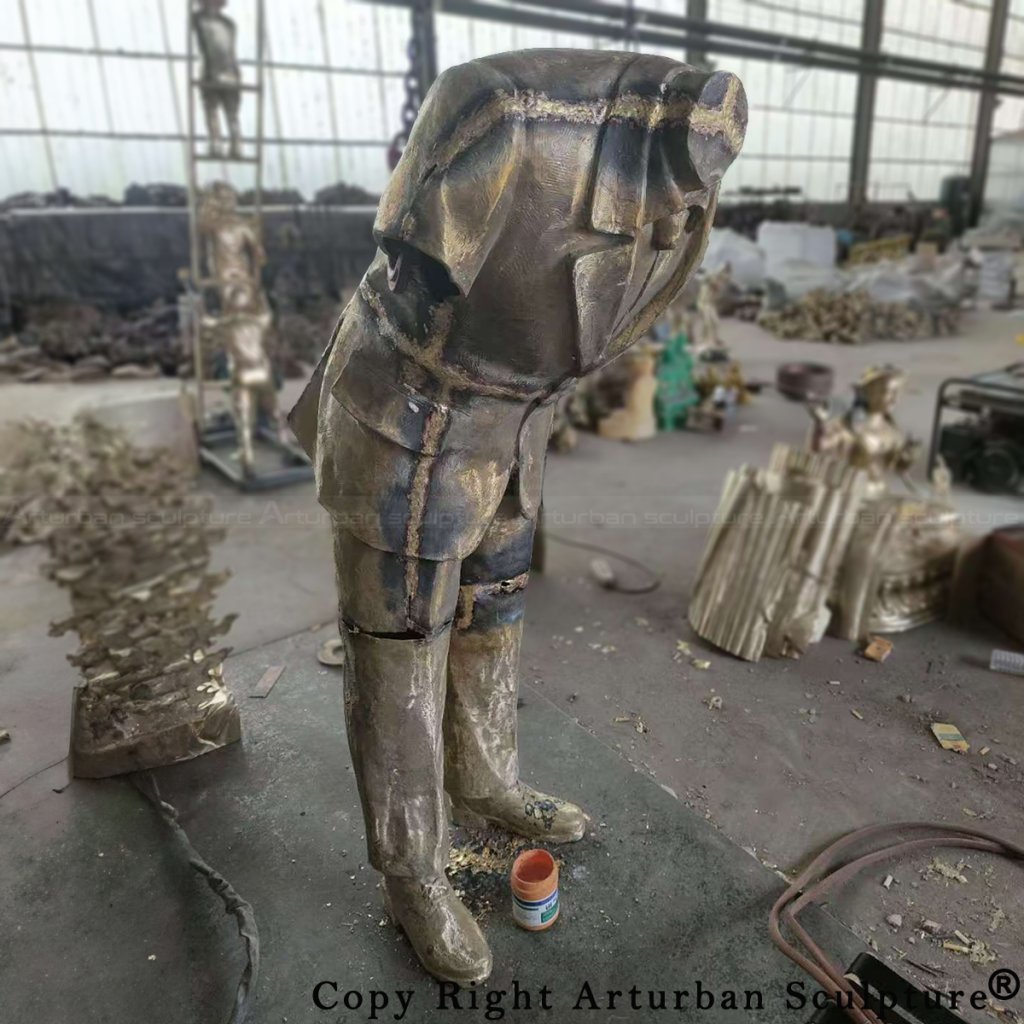 Bronze cast of the Corporate Head Sculpture before surface treatment, showing welding seams