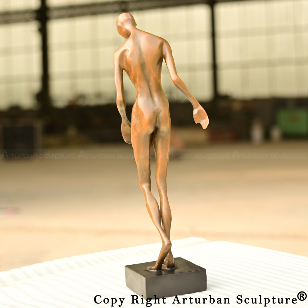 8-Elegant bronze abstract human sculpture leaning forward in a delicate walking motion