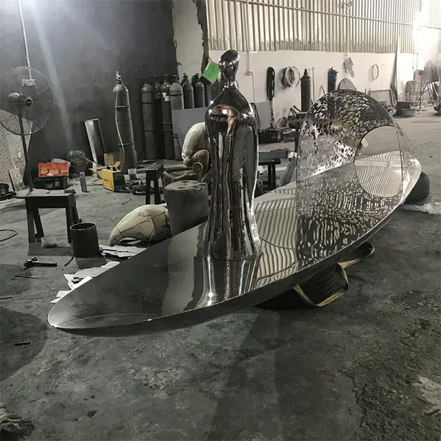 Abstract Boat Sculpture in stainless steel showing human figure standing
