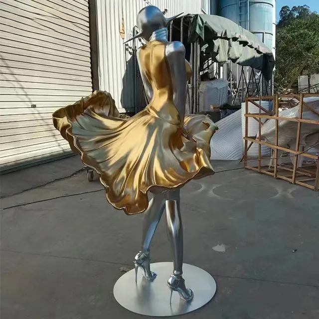 Back view of gold and silver stainless steel female statue art inspired by Marilyn Monroe