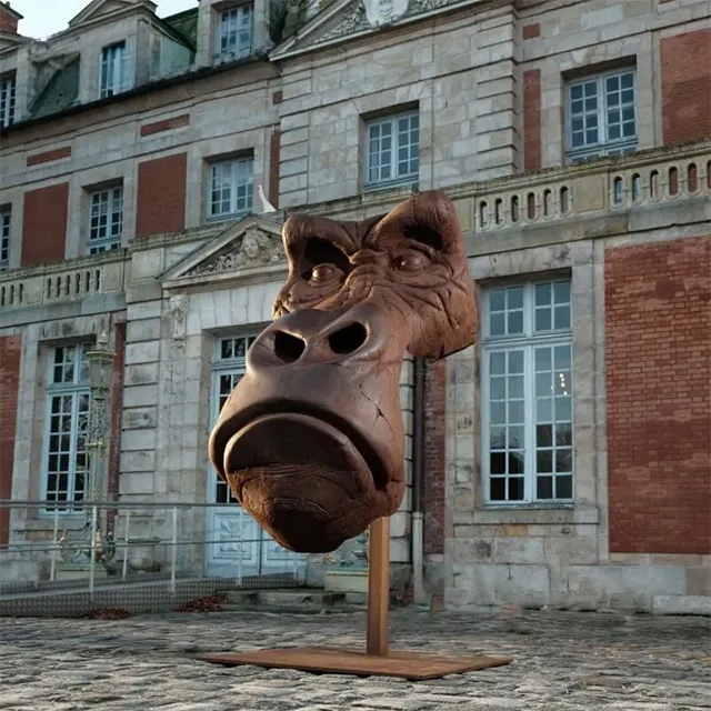 Bronze Gorilla Bust statue in front of a classical French building